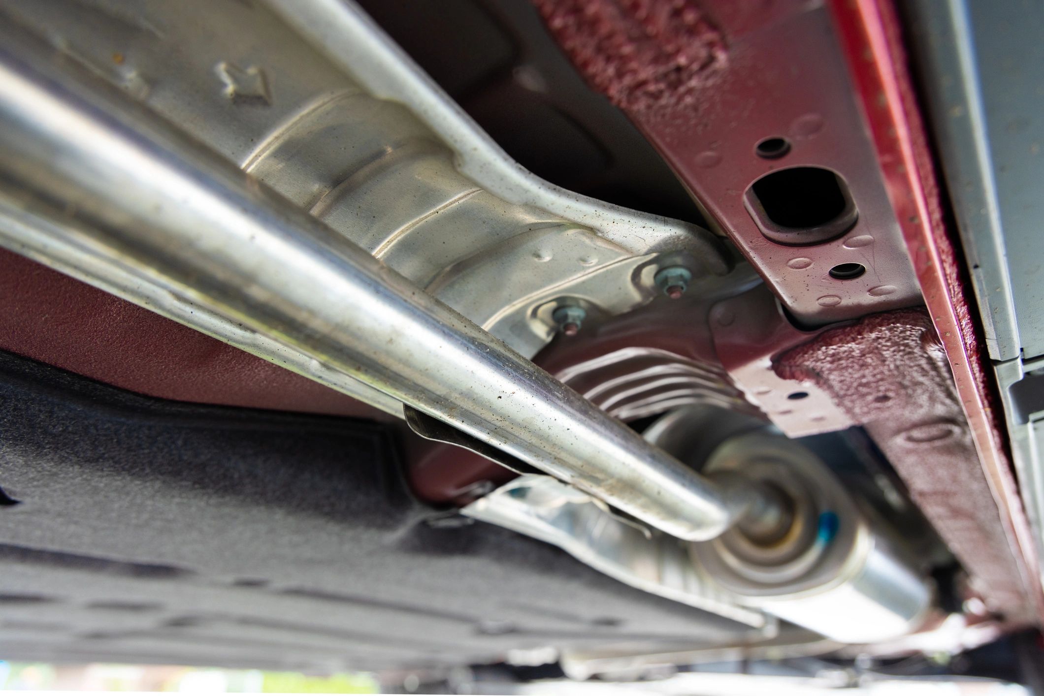 Vehicle underside and parts in repair workshop